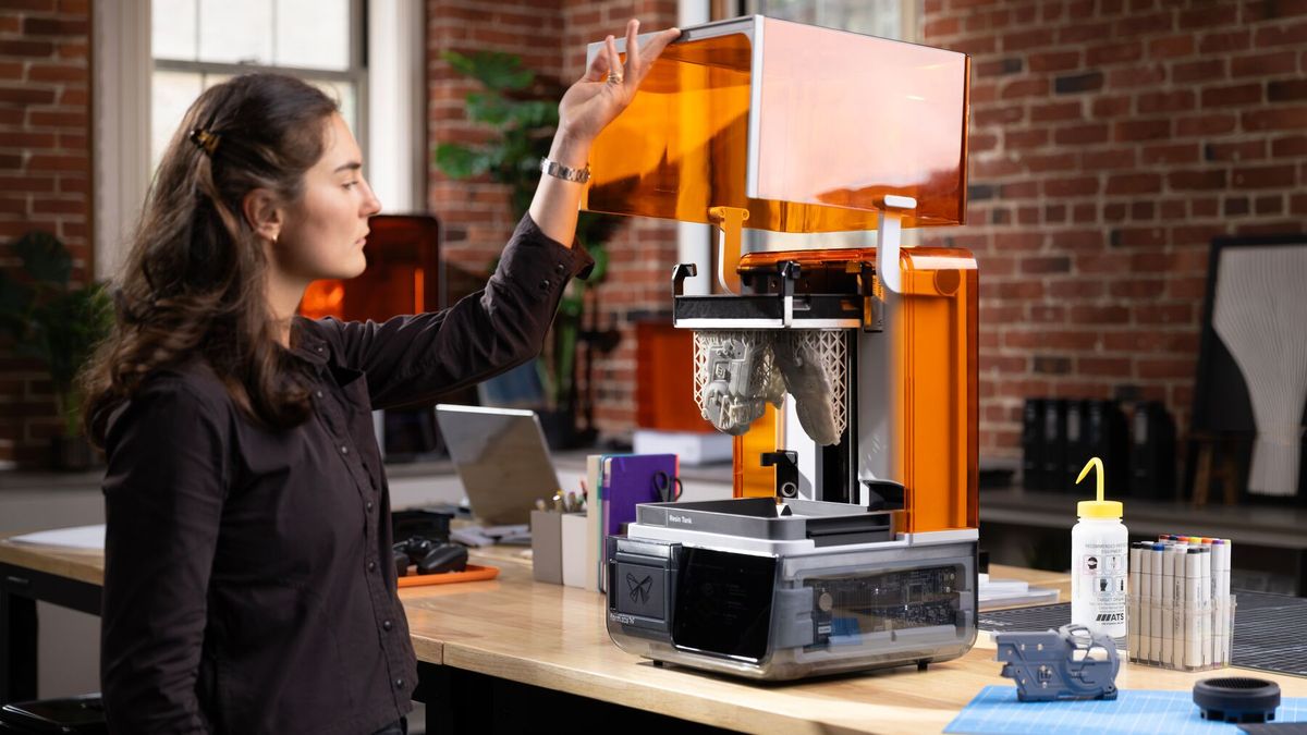 An engineer opening Form Studio 1 at a desk in a brick-walled office