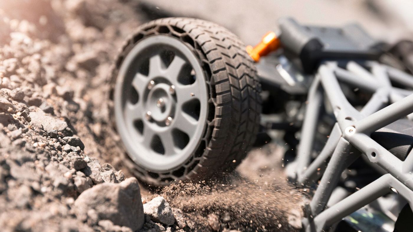 Printed RC car wheel and frame kicking up dirt