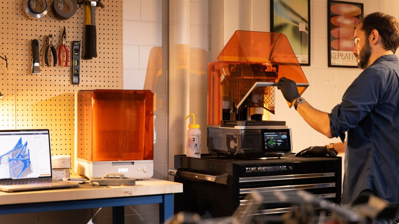 A person opening the cover of Form Studio 1 in a workshop