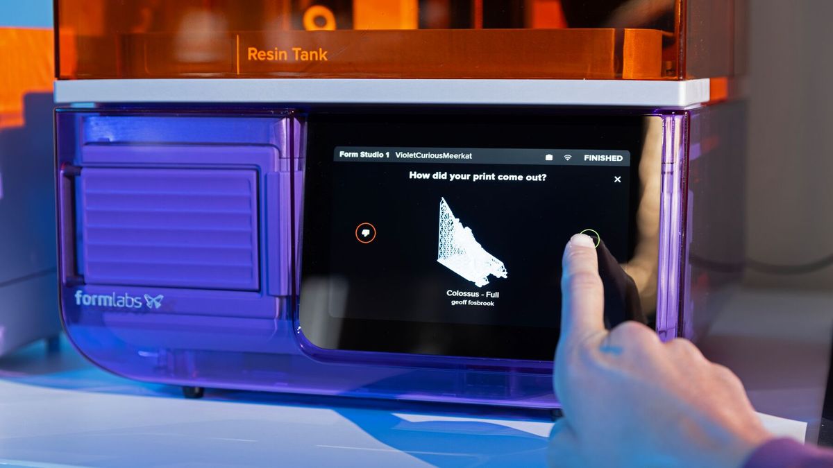 A finger tapping the Form Studio 1 touchscreen after a print