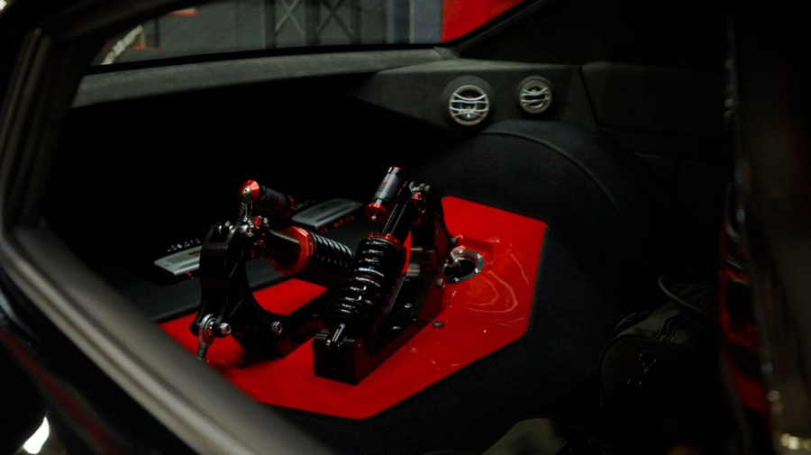 Custom automotive pedal assembly mounted on a red interior panel