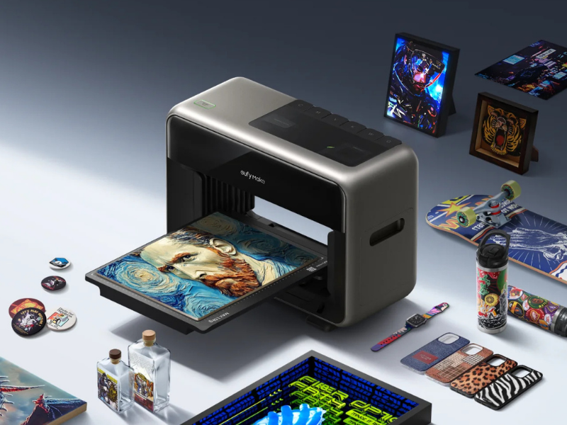 eufyMake E1 UV printer with finished prints on a variety of materials
