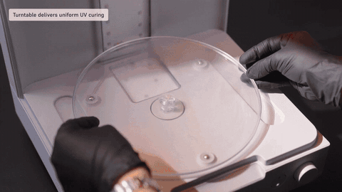 A part turns on the Form Studio Wash+Cure turntable under curing light