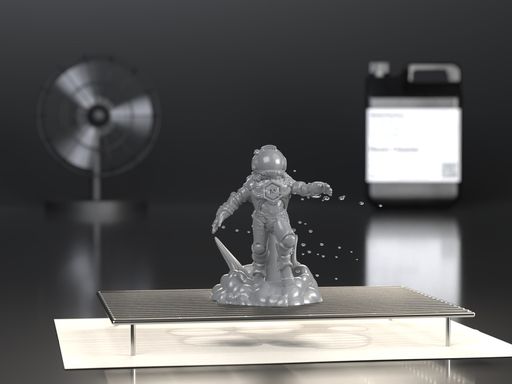 Rinsed resin miniature air drying on a wire rack in front of a desk fan