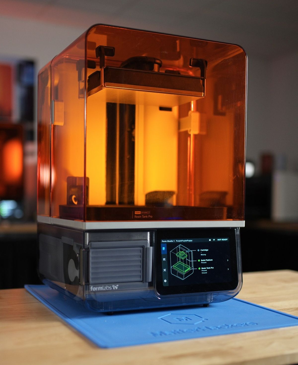 Our Form Studio 1 demo unit glowing orange on a MatterHackers mat